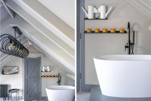 a bathroom with a white bath tub and a staircase at La Retraite in Wolferton +49 photos