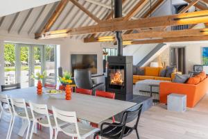a living room with a table and a fireplace at La Retraite in Wolferton