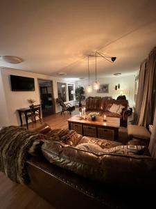 a living room with a couch and a table at Hotelletvidfjallet in Transtrand