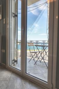 a sliding glass door with a view of the ocean at Stella Di Mare Pylos in Pylos
