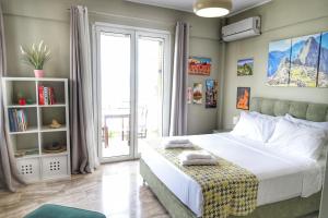 a bedroom with a bed and a large window at Stella Di Mare Pylos in Pylos