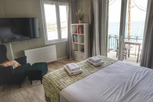 a bedroom with a bed with two towels on it at Stella Di Mare Pylos in Pylos