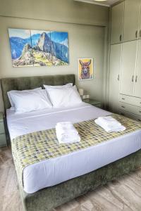 a bedroom with a bed with two towels on it at Stella Di Mare Pylos in Pylos +45 photos