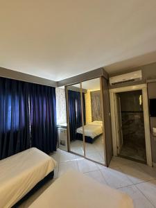 a hotel room with two beds and a mirror at فندق كلاسيك in Aqaba