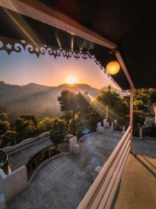 a view of the sunset from a house balcony at Prarambh Cottages in Bhowāli
