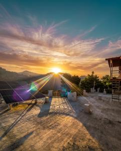 a view of the sunset from the roof of a building at Prarambh Cottages in Bhowāli
