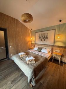 a bedroom with a large bed in a room at Sky hugs cottage in Volosyanka