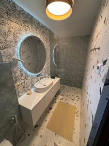 a bathroom with a sink and a mirror at Sky hugs cottage in Volosyanka +16 photos