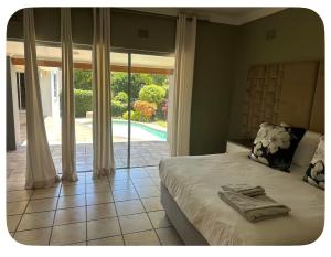 a bedroom with a bed and a large sliding glass door at mission lifestyle in Empangeni