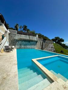 a large swimming pool with blue water at Vista Mare Samaná in Punta Balandra
