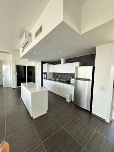 a large kitchen with white cabinets and a counter top at Vista Mare Samaná in Punta Balandra