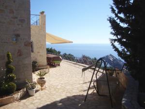 a patio with a view of the ocean from a house at Villa koukla horizon in Agios Nikolaos