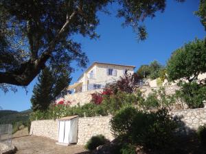 a house on top of a stone wall at Villa koukla horizon in Agios Nikolaos