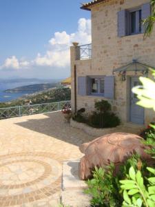 a house with a balcony with a view of the ocean at Villa koukla horizon in Agios Nikolaos +11 photos