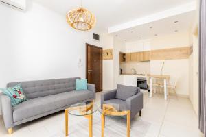 a living room with a couch and a chair at Lavender Bay E2-1-studio apartment in Donji Morinj