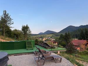a group of chairs sitting on top of a building at Sky hugs cottage in Volosyanka