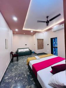 a bedroom with two beds and a ceiling at Awadh kunj palace in Ayodhya
