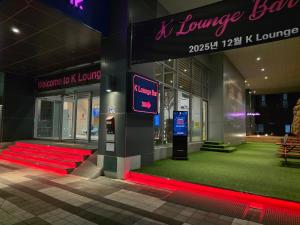 a building with red lights in front of a store at Hotel K-Tree Pyeongtaek in Pyeongtaek