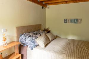 a bedroom with a bed and a wooden table at Casa Fontenario in Vila Real +1 photo
