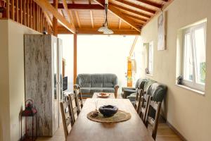 a dining room with a wooden table and chairs at Casa Fontenario in Vila Real