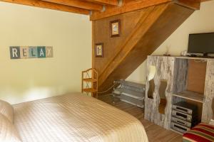 a bedroom with a bed and a tv in a room at Casa Fontenario in Vila Real