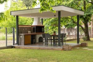a pavilion with a table and chairs in a yard at Elena luxury living in Paralía Skotínis