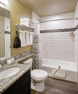 a bathroom with a tub and a toilet and a sink at Waybound Yosemite in Fish Camp +6 photos