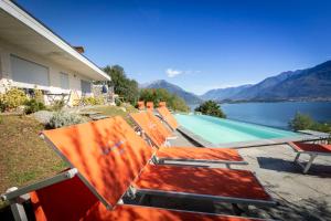 a group of lawn chairs sitting next to a swimming pool at La Collina dei Fiori in Vercana