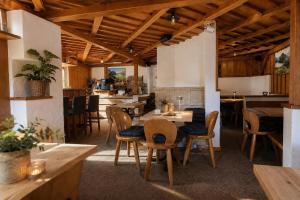 a dining room with wooden tables and chairs at Alpinchalet Zigjam in Gaschurn
