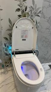 a toilet with the seat up in a bathroom at Travellers Staycation in San Jose del Monte +11 photos