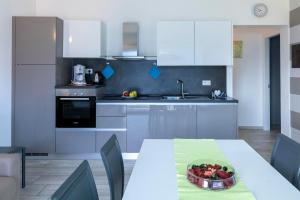 a kitchen with a table with a bowl of fruit on it at La Collina dei Fiori in Vercana