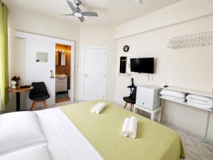 a white bedroom with a bed and a bathroom at Smart Comfort RoomN3 with Private Bathroom in best Location Beach 250m in Limassol