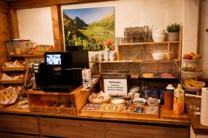 a bakery with a counter with food on it at Alpinchalet Zigjam in Gaschurn