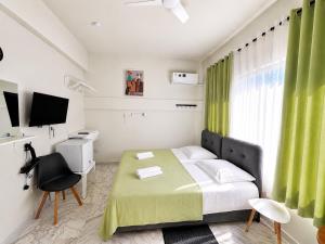 a bedroom with a bed and a desk and a television at Smart Comfort RoomN3 with Private Bathroom in best Location Beach 250m in Limassol
