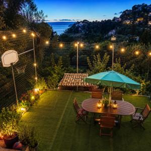a patio with a table and chairs with an umbrella at Pantanassa House in Nisaki