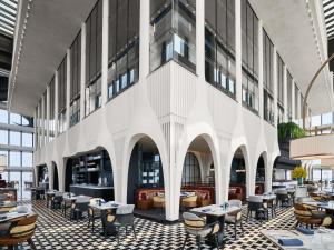 a restaurant with tables and chairs in a building at Fairmont Xiamen in Xiamen