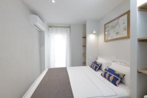a bedroom with a white bed and a window at Maison entière à 100m de la mer in Antibes +19 photos