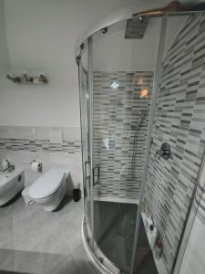 a bathroom with a shower and a toilet and a sink at Attico Sole e Mare in Ventimiglia +17 photos