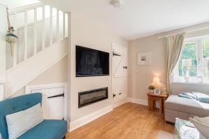 a living room with a fireplace and a tv at 3 Bed in Beadnell oc-44965 in Beadnell