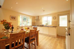 a kitchen with a table and chairs and a dining room at Hen Gapel in Aberhosan