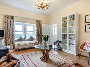 a living room with a table and a couch at 2 Bed in Arbroath oc-90316 in Inverkeilor