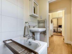 a white bathroom with a sink and a bath tub at 2 Bed in Arbroath oc-90316 in Inverkeilor +31 photos