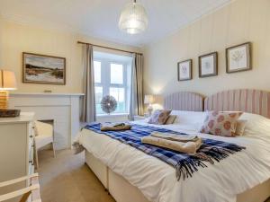 a bedroom with a bed with towels on it at 2 Bed in Arbroath oc-90316 in Inverkeilor