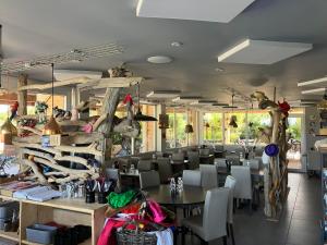 a dining room with a table and chairs at Camping familial 3 Etoiles avec piscine Carrefour de l'Ardèche in Saint-Remèze