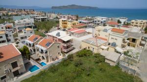 an aerial view of a city with houses and the ocean at Villa Christy in Stalos