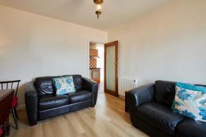 a living room with a couch and a chair at Host & Stay - The Beach in Filey +15 photos
