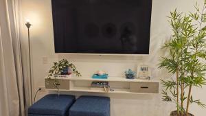 a living room with a tv on a wall at Xonadu con dominio in Puerto Plata