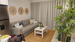 a living room with a couch and a table at Xonadu con dominio in Puerto Plata