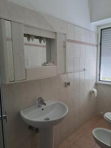 a bathroom with a sink and a mirror at Hotel Le Onde in Terracina