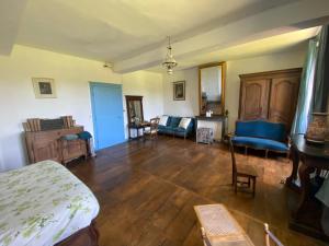 a living room with a bed and a table and chairs at Chateau de Grandsagne in Bonnat